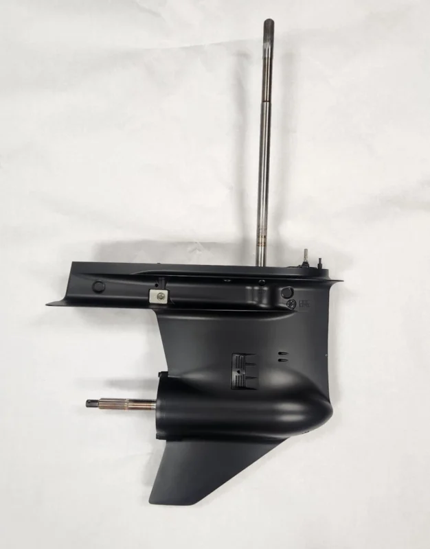 Refurbished Suzuki lower unit with new gears and seals installation in a marine workshop